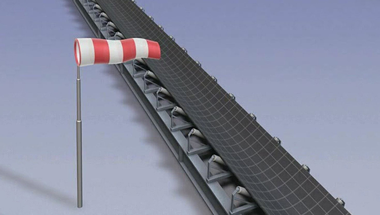 When a belt conveyor is not covered wind can push the belt out of the center.
<br><br>This depends on
<ul>
<li>the wind speed</li>
<li>the belt width</li>
<li>the troughing angle therefore the vertical area of the belt in the wind</li>
<li>the belt weight which pulls the belt into the trough</li></ul>

Here the mistracking of the belt can be seen, which results from constant wind force acting on the belt.