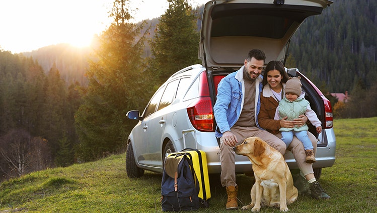 Parents, their daughter and dog near car in mountains, space for text. Family traveling with pet; Shutterstock ID 2280729171; purchase_order: Auto; job: Vegan Campaign; client: ; other: