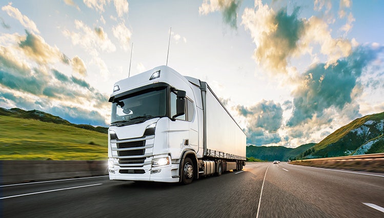 Truck with container on highway, cargo transportation concept. Shaving effect.